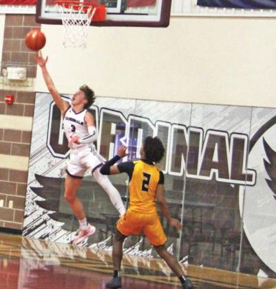 Lingleville Cardinal Garrett Hurt leaps past Iredell Defense under the net in the Jan. 31 home game. Paul Gaudette | Citizen staff photo