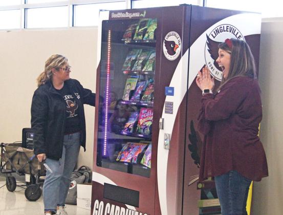 Lingleville ISD teachers Lisa Haley and Alexa Garrison celebrate the unveiling of a book vending machine in the school cafeteria with a ribbon cutting Jan. 17. Wyndi Veigel-Gaudette | Citizen staff photo