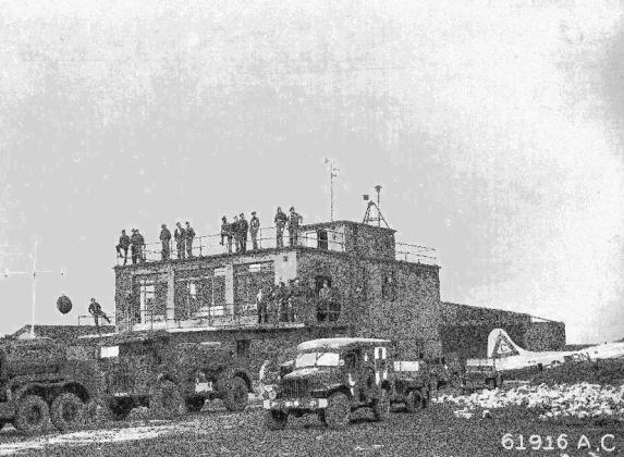 Men would gather on top of the air field tower to watch for planes returning from their missions. RAF Molesworth/photo public domain