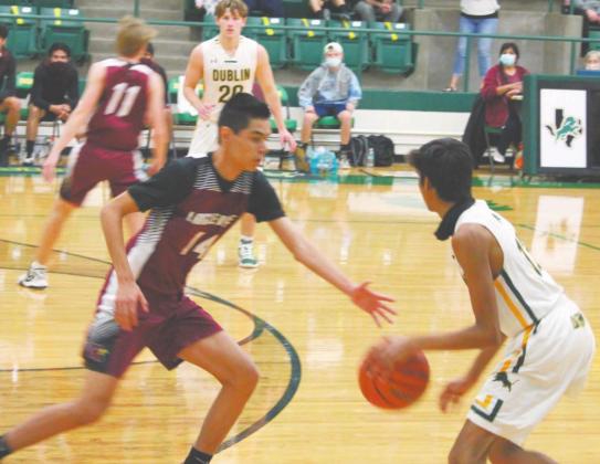 Dublin Lion Ayush Patel looks to pass the ball to teammate Cole Moore past Lingleville defense in a Saturday home game. Sara Gann | Citizen staff photo