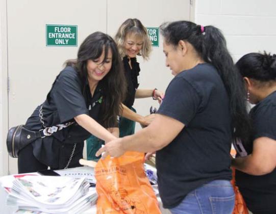 Chamber of Commerce President Blanca Martineau and Board Member Sandra Espinosa hand out give-a-ways from local businesses. Wyndi Veigel | Citizen staff photo