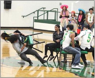 DHS cheerleader Emma Vargas and Sound of Dublin band member Alex Ponce DeLeon topple a chair to the gym floor during the pep rally Friday, Sept. 1 as students and staff fought hard in a spirited game of musical chairs. After the smoke cleared, Aidan Hernandez took top honors, narrowly beating out Ayden Vargas. Far left, Kaden Gaitan spoke to the pep rally crowd before scoring the sole TD in Friday night’s game. Paul Gaudette | Citizen staff photo