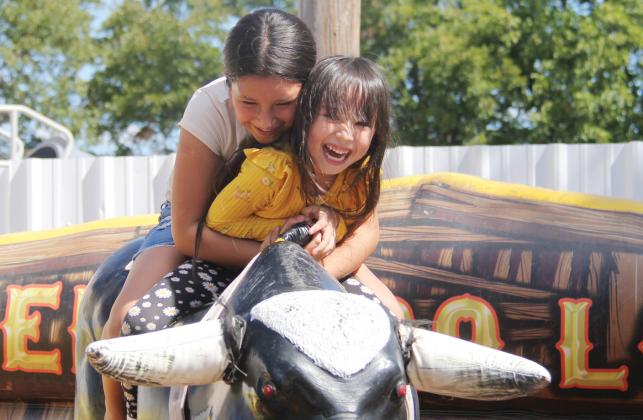 Young girls enjoy riding a mechanical bull at the annual Hispanic Heritage Festival Saturday, Sept. 30 hosted by the Dublin Chamber of Commerce. The event showcased a day of fun including boxing, more than 60 vendors, tasty food, games, a rodeo with escaramuza and a cabalgata (trail ride). For more photos of the event, see page A8 and go to the Dublin Citizen Facebook page. Wyndi Veigel | Citizen staff photo