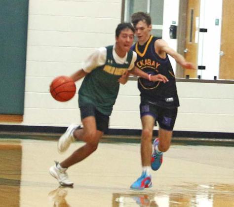 DHS basketball player Alex Teten dribbles the ball around Huckabay defense in a June 23 game that went into overtime. Paul Gaudette | Citizen Staff Photo