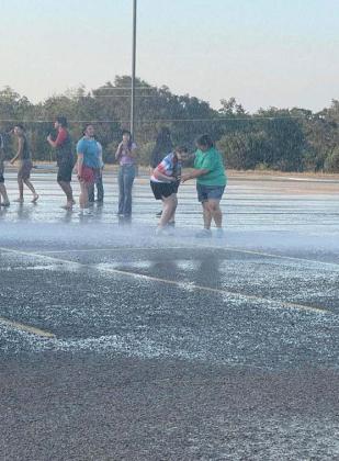 Band students enjoy cooling down with the help from the Dublin Volunteer Fire Department who sprayed water into the air for students to play in after a long rehearsal. | Courtesy photo