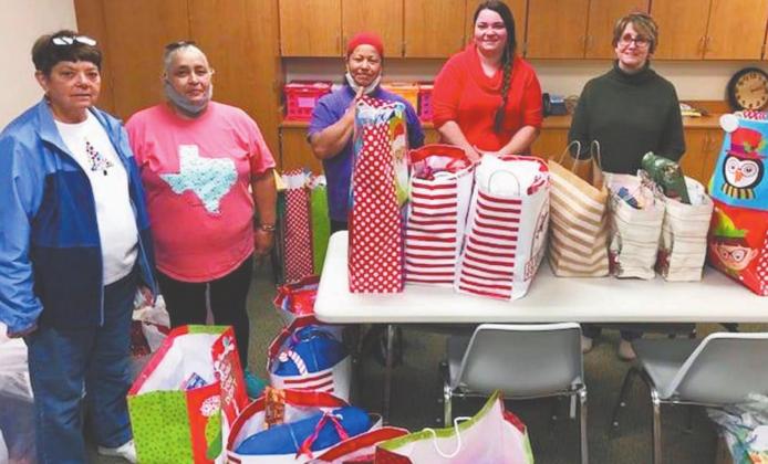 Dublin Christian Women’s Job Corps volunteers were busy last week wrapping gifts for 51 children and seniors in need that were delivered Thursday. The organization was aided in its effort this year by Dollar General who provided some of the gifts through its toy drive. | submitted photos