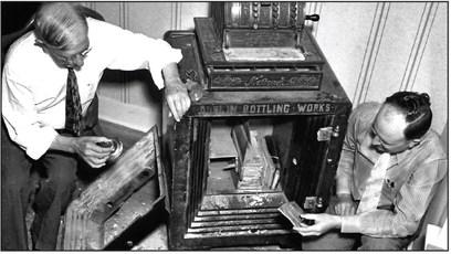 The safe at Dublin Bottling Works was blown open on the night of June 8, 1938. The robbers took cash and merchandise from 4 businesses in downtown Dublin. Sam Houston Prim, left, and an unknown man inspect the damage at the Dublin Bottling Works. Courtesy photo