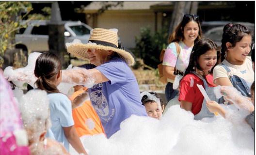 Wyndi Veigel I Citizen staff photo Volunteer Wanice Brown played in bubbles with the rest of the kids as they enjoyed a foam machine at the Back-to-School Fair. Adults and kids alike took the opportunity to have a fun, sudsy trip into childhood enjoyment. For more photos see the Dublin Citizen Facebook page.