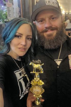 Brooke and Josh Mendenhall from Bar-Lee BBQ hold the trophy from the annual Mr. Legs contest. Josh was declared the winner. Courtesy photo