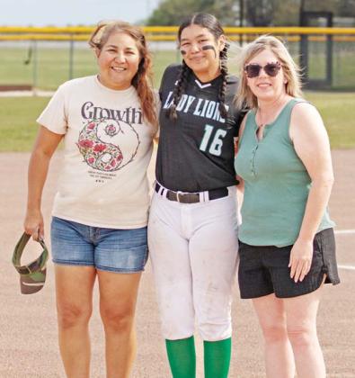 Danielle Meador | Citizen staff photo Dublin Lady Lion Nomi Thompson leans in to catch a ball from an Early Hitter while team mate Olivia Salyer stands by in their final home game of the season Thursday, April 17. Senior Lady Lion Anabel Phelps was escorted onto the field by family and friends and was presented gifts in honor of the final softball game of her high school career.