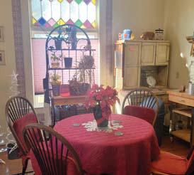 A beautiful stained glass window and red decor are part of the Weems’ home.