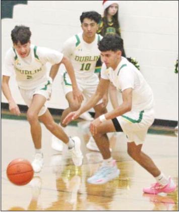 Dublin Lions Kaden Gaitan, Alex Teten and Francisco Garcia swing around to advance the ball up the court in a recent home game. Paul Gaudette | Citizen staff photo