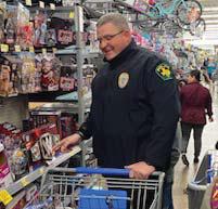 Dublin Police Chief Cameron Ray checks out all the cool toys while helping with Shop for a Cop. Submitted photo