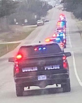 Submitted photo Law enforcement and Erath County children ride from The Purple Goat to Walmart to go shopping for the Shop with a Cop event. The kids are allowed to ride with law enforcement with lights and sirens to the annual event.