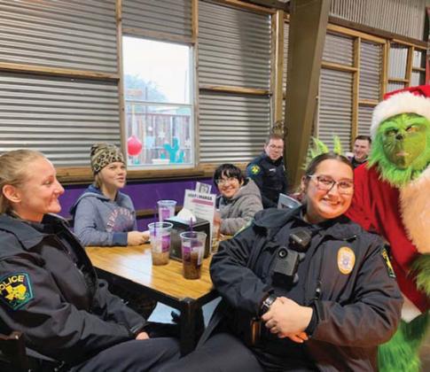 Dublin Police Officers Brandi Hoffman and Kristi Bonilla caution the Grinch against stealing Christmas items while at breakfast with youngters for Erath County’s Shop with a Cop event Thursday, Dec. 22. Submitted photo