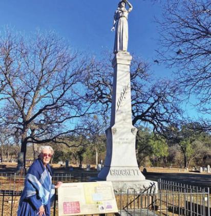 Carolyn Cotton, direct descendant of Elizabeth and David Crockett, standing at Acton Cemetery in front of the statue of Elizabeth Crockett. | submitted photo