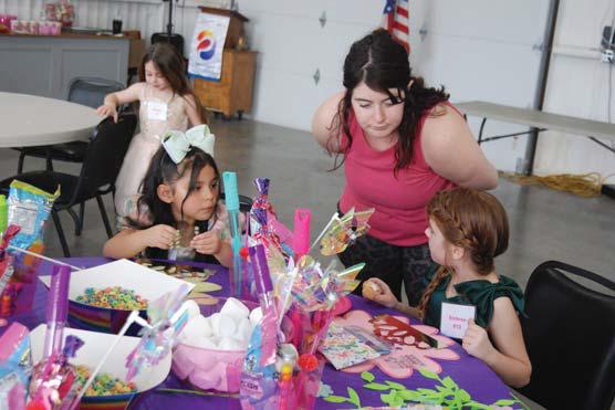 Pageant organizer Jaclyn Baugh assists Little Miss Dublin contestants at the tea party Sunday, March 3. Paul Gaudette | Citizen staff photo