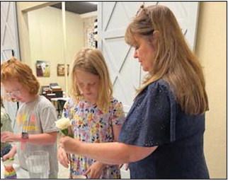 A young lady is taught floral arranging by Cross Timbers Fine Arts Council. Submitted photo
