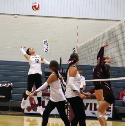 Lingleville Lady Cardinal Denise Toledo leaps up to smack the ball back against Zephyr in a home game Tuesday, Aug. 19. Paul Gaudette | Citizen staff photo