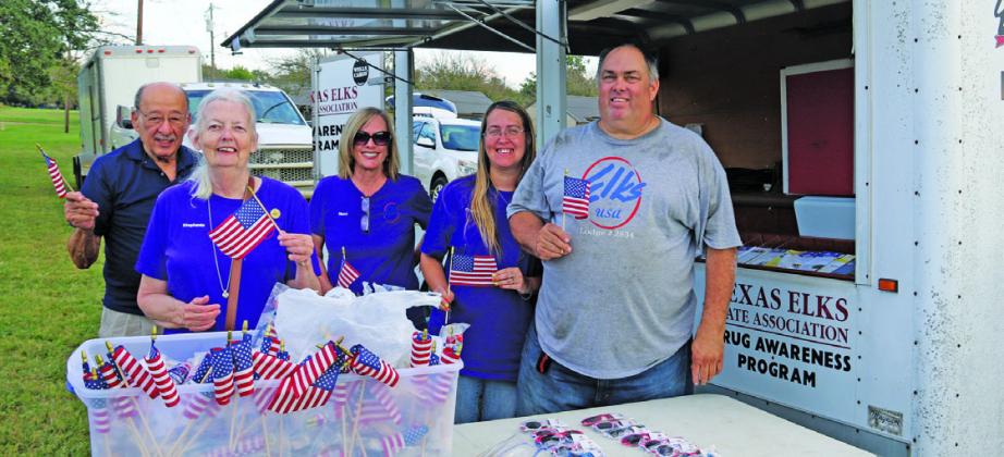 DQ hands out icy treats. Above, Stephenville Area Elks Lodge members hand out flags. Paul Gaudette | Citizen staff photos