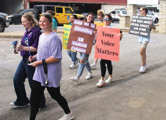People of all ages carry signs during the Stop the Silence rally Tuesday, April 29 around the downtown Stephenville Courthouse. Paul Gaudette | Citizen staff photo