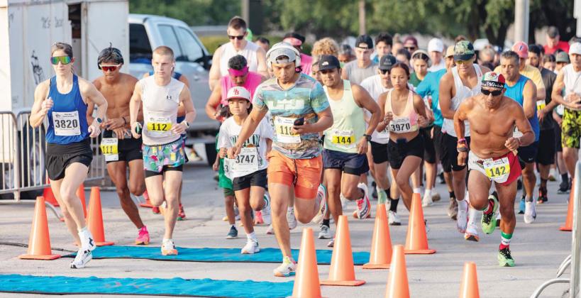 Runners bolt through the starting line near the Dublin Public Library during the Irish Stampede hosted by the Lions Club Saturday, June 14. Danielle Meador | Citizen staff photo