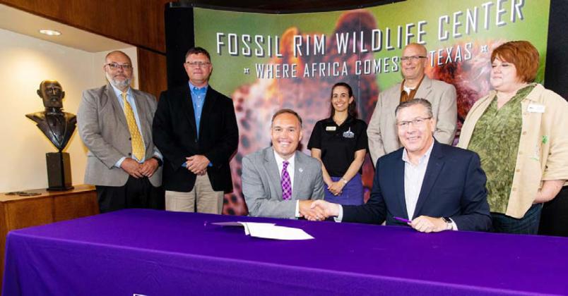 Tarleton President James Hurley, left, shakes hands with Dan Simon, Fossil Rim Executive Director as the two finalize an agreement between the two entities Thursday. | submitted photo