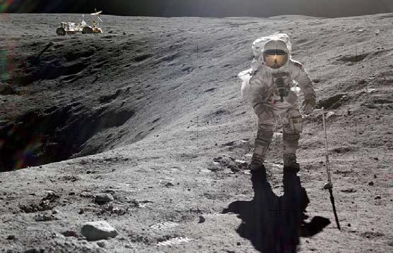 Astronaut Charlie Duke, lunar module pilot, is photographed by astronaut John W. Young, commander, collecting lunar samples during the first Apollo 16 extravehicular activity (EVA) at the Descartes landing site. Duke is standing at the rim of Plum Crater. The parked Lunar Roving Vehicle (LRV) can be seen in the left background. | NASA