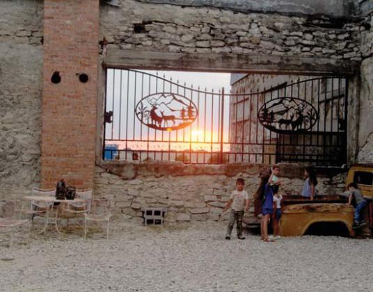 Kids of all ages play inside Rancho Viejo during the open house as the sun sets in the background. Below, a large enclosed room is on display as part of the event venue. Wyndi Veigel-Gaudette | Citizen staff photo