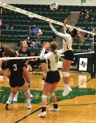 Dublin Lady Lion Kylie Olvera takes to the air to return a ball during Saturday’s home game against the Millsap Lady Bulldogs while Madilyn Loper stands by for coverage. The game resulted in a four-set loss for the home team. Paul Gaudette | Citizen staff photo