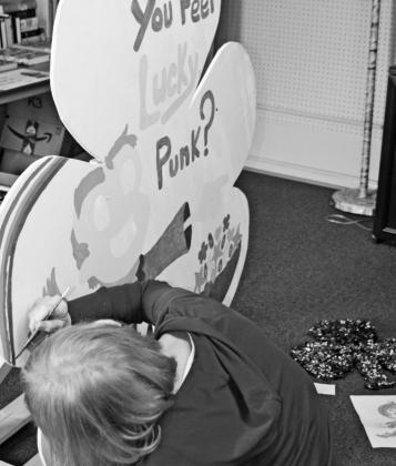 Dublin Citizen business manager Cindy Combs paints a shamrock to be displayed as part of a fundraiser for the Dublin Rodeo Heritage Museum. Dozens of shamrocks have been placed around town to be decorated in conjunction with the St. Pat’s festivities. Paul Gaudette | Citizen staff photo
