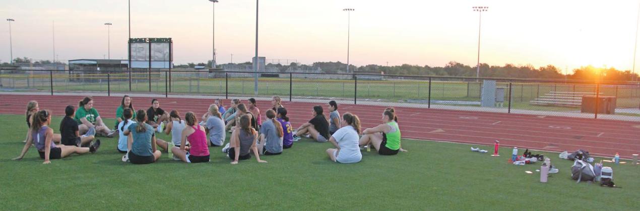 Dublin Lady Lion head volleyball coach Nikki Granath talks to DHS Lady Lions volleyball players as they sit on Cervetto Field following a run on the track. The teams will hit the court for the first time this season on Tuesday, Aug. 8 as the JV and Varsity Teams take on Hamilton in games starting at 4:30 p.m. They will follow this with an appearance in the Albany Tournament Aug. 10-Aug. 12. Paul Gaudette | Citizen staff photo