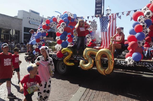 A 'Better With Dairy' float shows off some enthusiastic 'cows' handing out tubes of yogurt along the parade route. The parade entry is in honor of Erath County's Dairy industry. Below, the reigning court for Miss Dublin rides on the newly redone Dublin Chamber of Commerce Ambassador float. Wyndi Veigel-Gaudette | Citizen staff photo