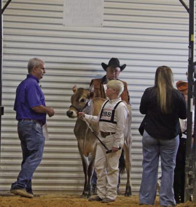 A competitor in the Dairy cattle show is greeted by Texas AgriLife Extension Agent Lonnie Jenschke at the annual Erath County Junior Livestock Show Monday, Jan. 5. Paul Gaudette | Citizen staff photo
