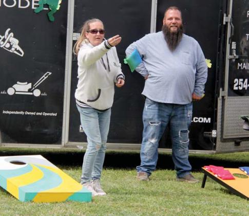 Cornhole tournament participants concentrate on perfecting tosses and scoring during the St. Patrick’s Day festival. Wyndi Veigel | Citizen staff photo