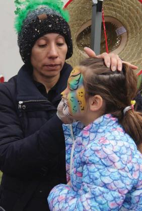 A young mermaid gets her face painted at the Dublin St. Patrick’s Day festival. Wyndi Veigel | Citizen staff photo