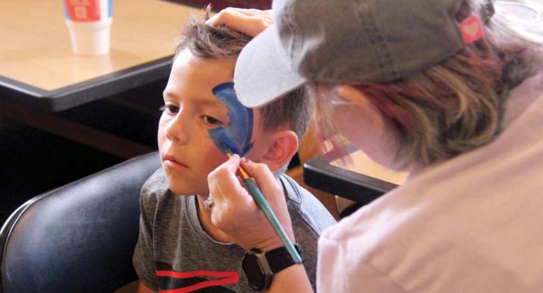 Kids were able to get their faces painted at Miracle Treat Day. A young boy gets a shark. Paul Gaudette | Citizen staff photo