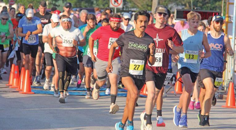 Runners in the Lions Club Irish Stampede 5K and 10K (above) rush through the gate Saturday, June 8. Dublin cheerleaders (below) were on hand to present medals as winners crossed the finish line. At bottom, runners in the 2K fun run disembark. Paul Gaudette | Citizen staff photos