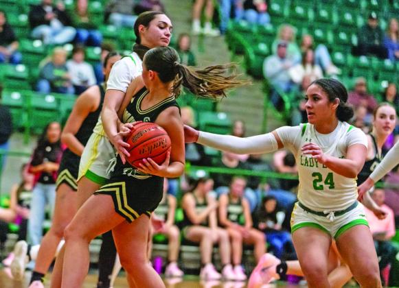 Lady Lions Olivia Salyer and Adriana Stewart close in on a Comanche ballcarrier during the Jan. 30 home game. The duo led in scoring for the home team. Danielle Meador | Citizen staff photo