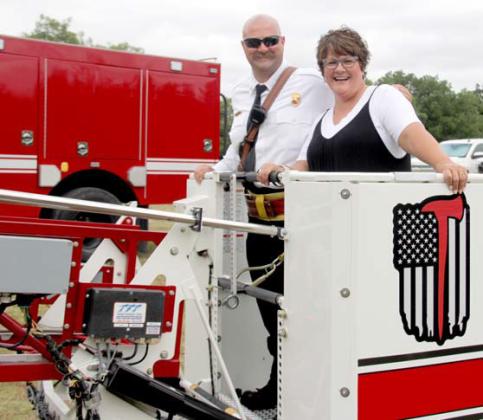 Division Chief of Operations Chris Elston and his mom Shelly Elston get ready for aerial views of Stephenville from the height of the Quint firetruck with a bucket. Wyndi Veigel | Citizen staff photo