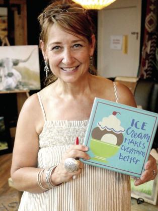 KayLee Pemberton with Blue-eyed Buffalo shows off decorative art work at the annual downtown ice cream event. We agree! Ice cream does make everything better. David Swearingen | Citizen staff photo