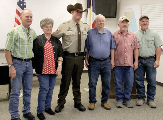 Erath County Sheriff’s Office Sgt. Chris Hill, center, is thanked by Jimmie and Carolyn Green and their three sons after the Greens were saved from a house fire by the deputy. He recently received the lifesaving award from Erath Sheriff Matt Coates. Wyndi Veigel | Citizen staff photo