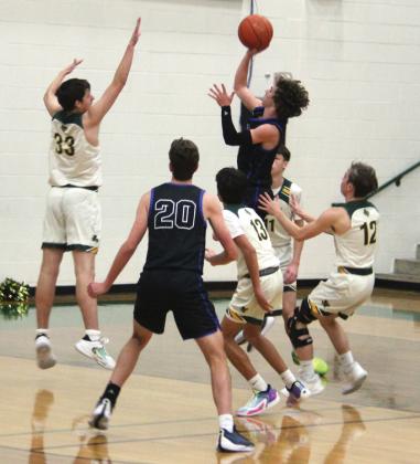 Dublin Lion Dane Lewis leaps up to block a Peaster Greyhound during the Tuesday, Dec. 19 home game while Alex Teten, Carson Ivie and Kyson Gilman rush in to assist. Paul Gaudette | Citizen staff photo