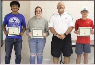 Junior high athletes Hudsen Joslin and Haden Keilers (not present) and High School athletes Francisco Garcia and Cassidy Adair. Presented by Athletic Director Greg Hardcastle. Athletic Scholars