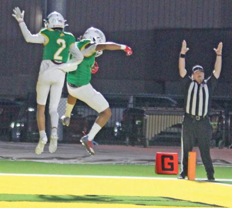 Dublin Lions Alex Teten and Francisco Garcia go airborne in celebration as a ref signals that Gracia successfully caught a pass from quarterback Kaden Gaitan for a touchdown Friday, Oct. 25 on Cervetto Field. The Lions won the game over the Eastland Mavericks 35-28. Paul Gaudette | Citizen staff photo