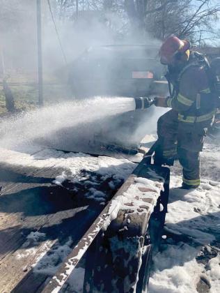 Firefighters utilize foam to help extinguish a gasoline fire to help prevent the spread of flames to a home. Courtesy photo