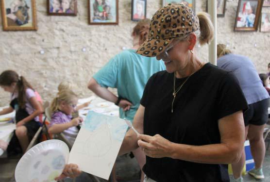 An instructor leads students in a painting exercise with blending and painting-by-number on a project. Wyndi Veigel | Citizen staff photo