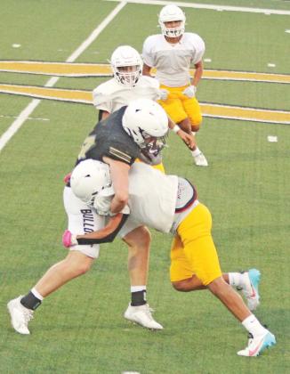 A Dublin Lion connects to bring down a Clyde Bulldog ball carrier during the away scrimmage on Thursday, Aug. 17 as teammate flank in to provide support. Paul Gaudette | Citizen staff photo