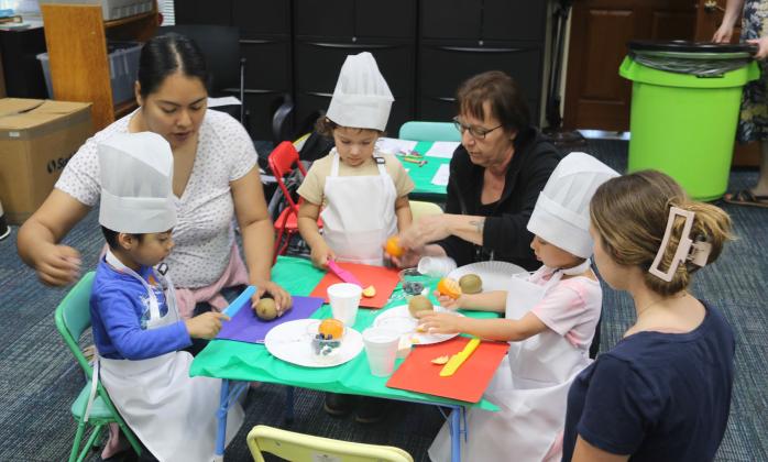 Kids work with their moms cutting up fruit for a butterfly-themed snack at the Mommy &amp;amp; Me class. Texas Agrilife Family and Community Health Extension Agent Andrea Brooks was on hand to help with the snack and food education course. Paul Gaudette | Citizen staff photo