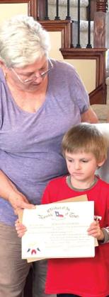 Bosque River Children of the Republic of Texas sponsor Judith Moore D’Amico presents membership certificate to newest chapter member Jackson Stover.